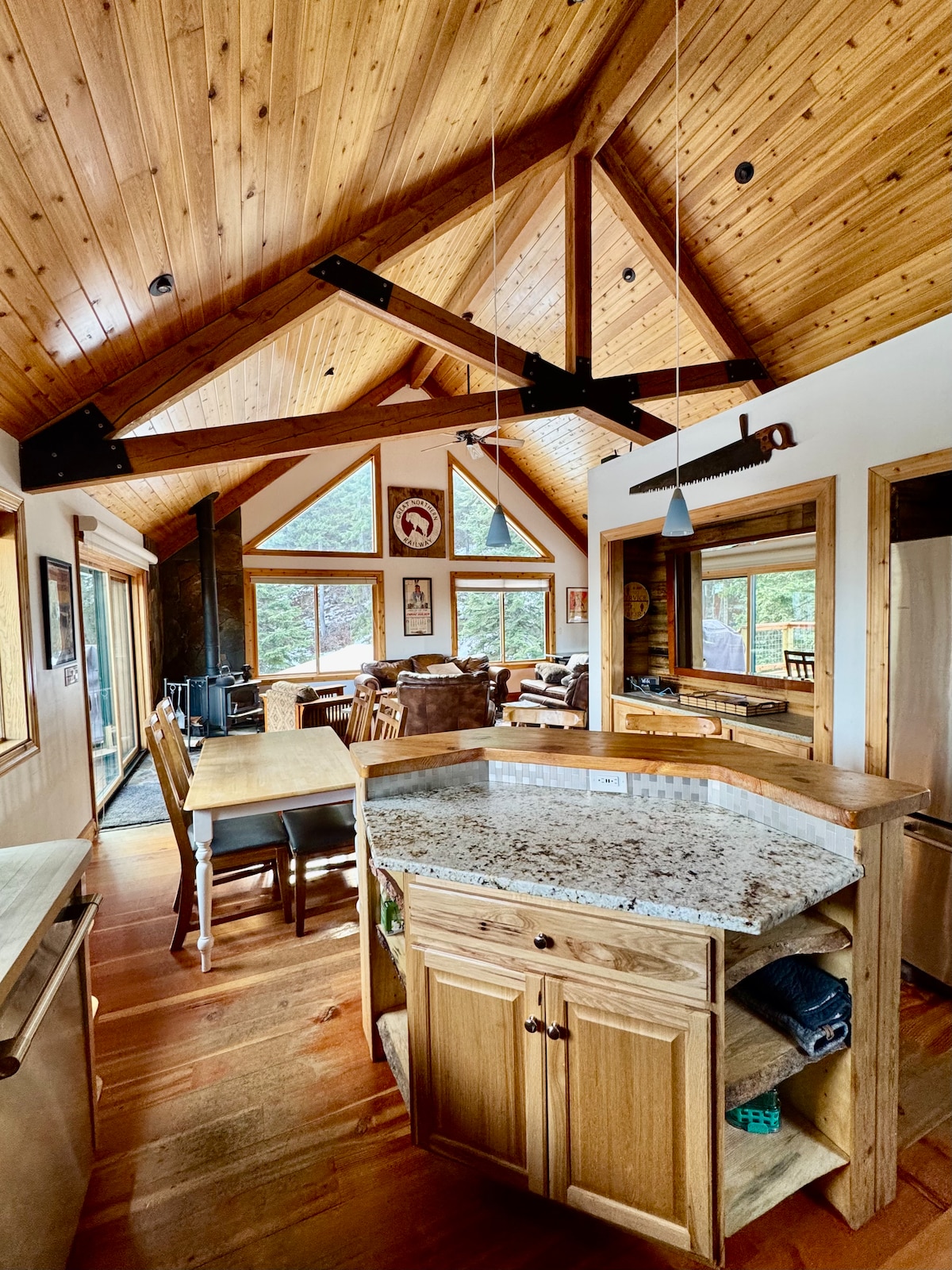 Open kitchen with vaulted timber ceiling and granite island