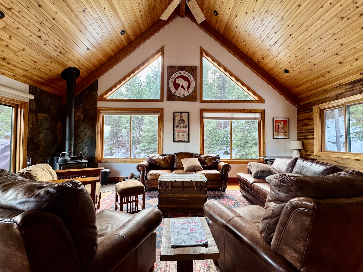 Vaulted living room with wood stove and leather couches