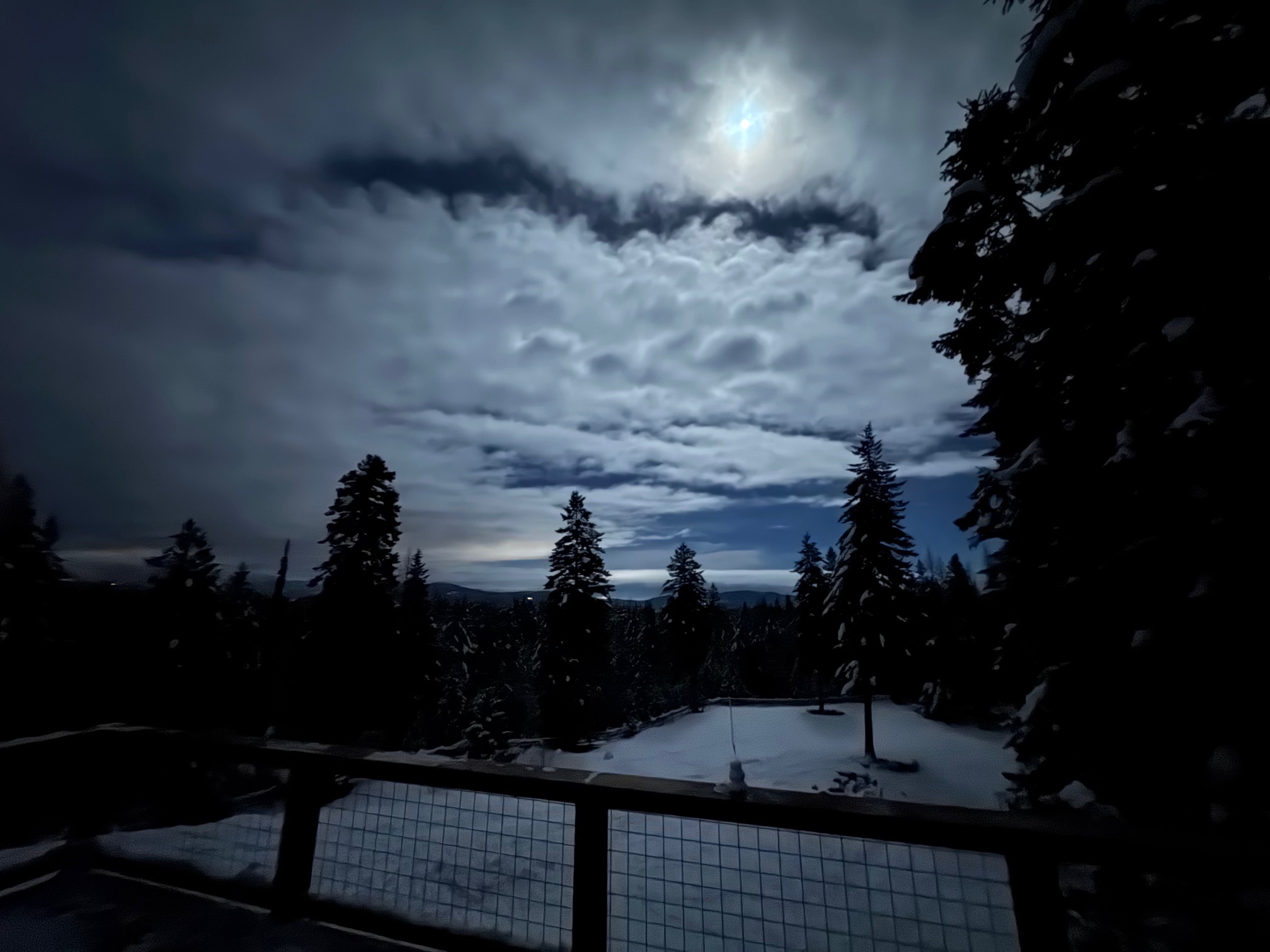 Moonlight illuminating the corral and mountains from the cabin deck at midnight