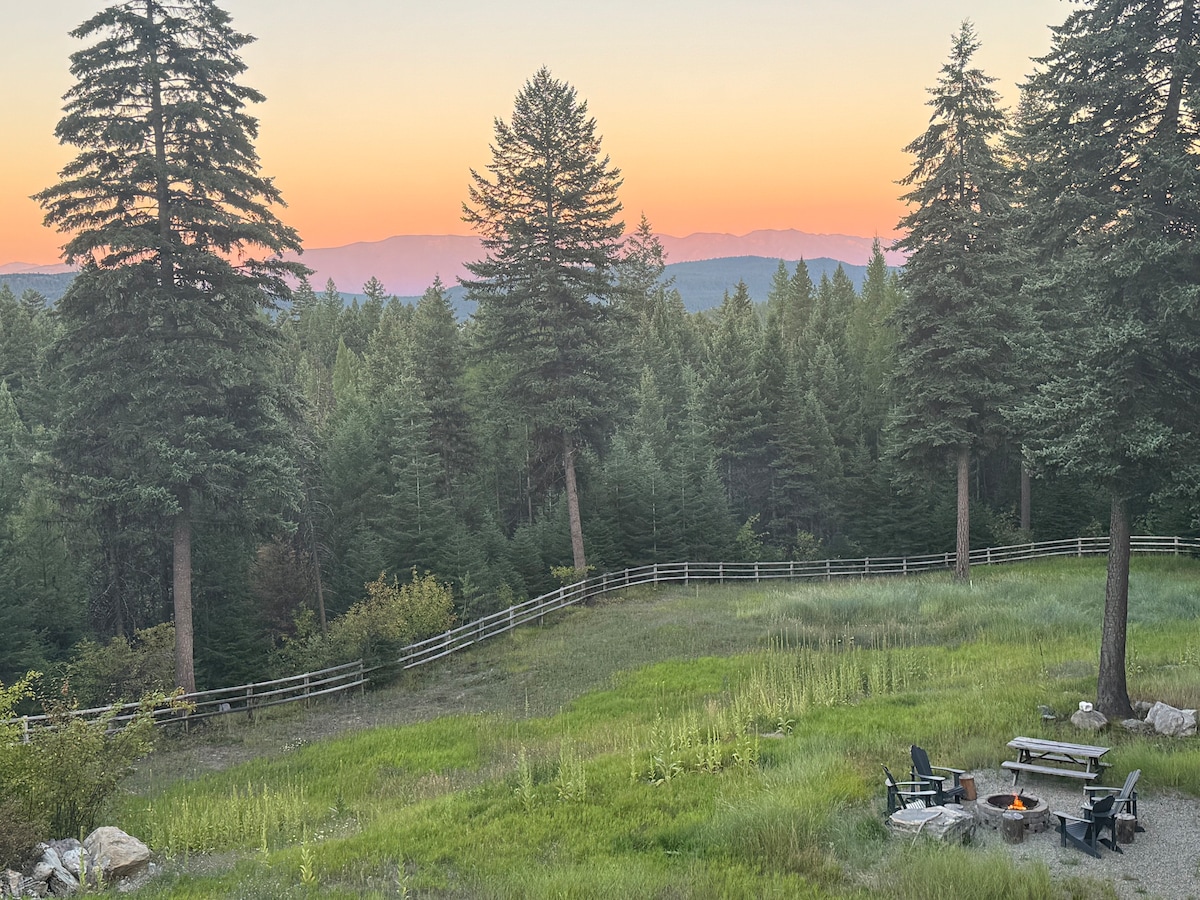 Sunset over the Montana mountains from the cabin meadow and fire pit